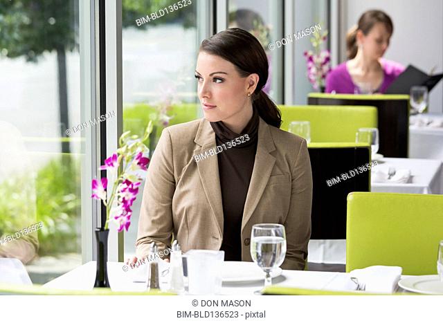 Caucasian businesswoman sitting in restaurant