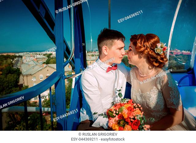Bride and groom in the Ferris wheel