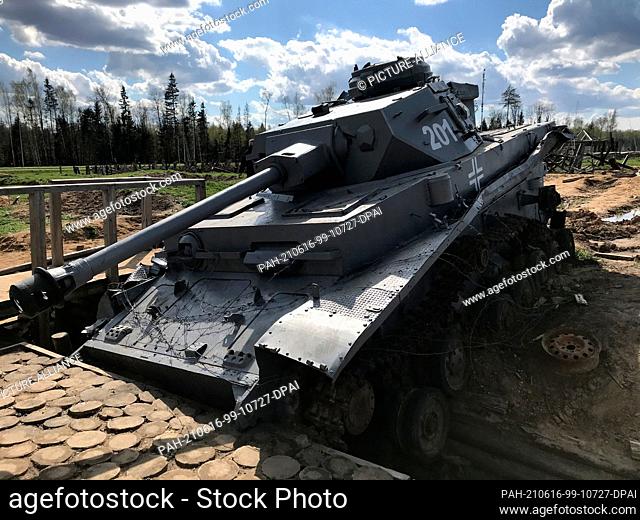 07 May 2021, Russia, Moskau: A destroyed German tank stands on a recreated battlefield. The scene is part of the ""Patriot Park"" built from scratch by the...