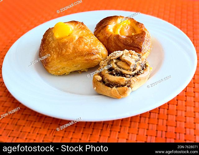 In the pictured three pastries served on a white plate