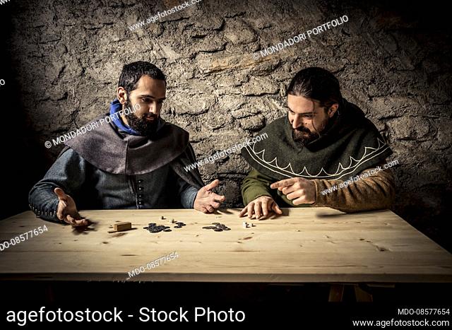 Middle Ages - second half of 14th Century. Hypothetical reenactment of Northern Italy customs and traditions. Winter, house interior: playtime with dices