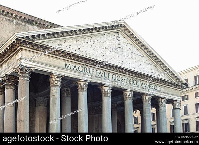 Details of a pediment and large granite Corinthian columns of the Pantheon, ancient Roman temple and Catholic church in Rome, Italy