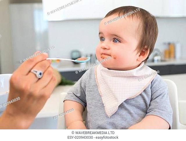 Innocent baby being fed by mother