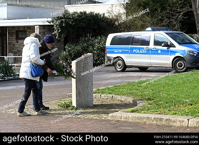 06 April 2021, Hessen, Kassel: Members of the initiative ""Nachgefragt"" lay a floral arrangement at the memorial stone for the NSU victims on Halitplatz