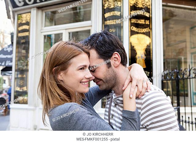 France, Paris, couple in love in front of pastry shop