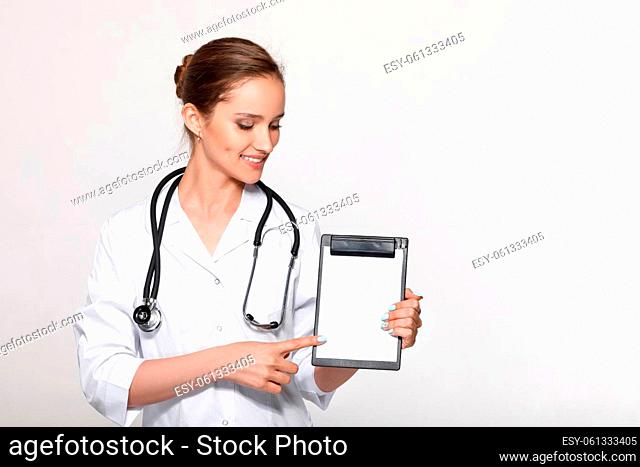 smiling medical doctor with stethoscope showing on empty blank