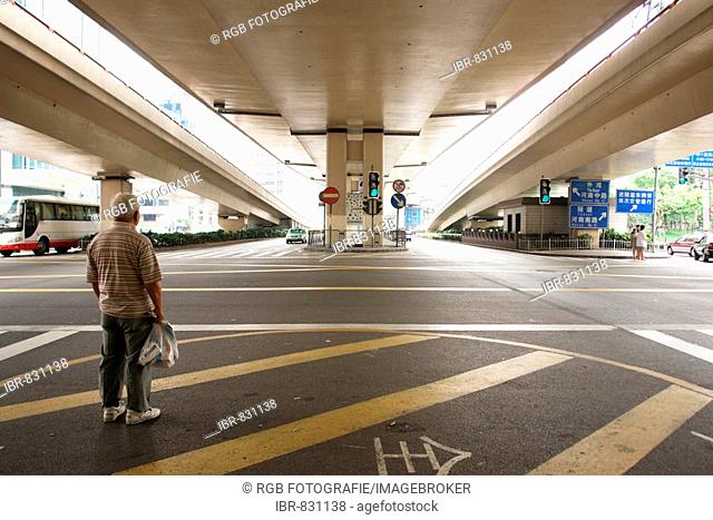 Man waiting under a freeway interchange in Shanghai, Shanghai Shi, China, Asia