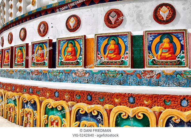 Buddhist reliefs adorn the Shanti Stupa in Ladakh, India. Conical in shape the stupa has several levels each accessible by stairways