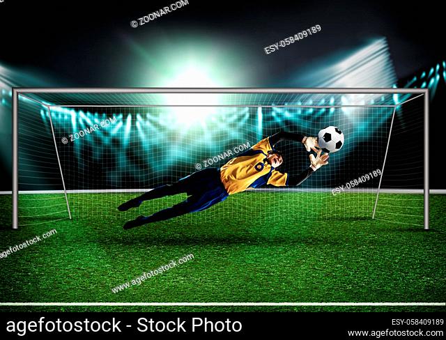 Goalkeeper in gates jumping to catching ball
