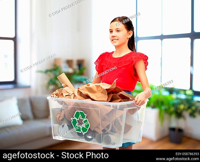 smiling girl sorting paper waste at home