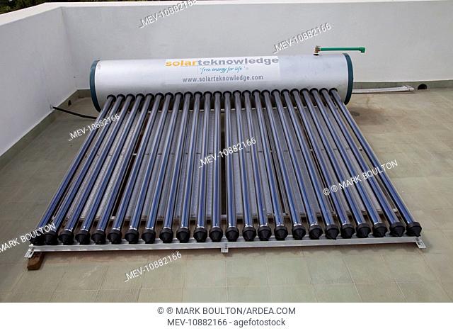 Solar thermal water heating system with tank and evacuated tubes on roof of house. Mombasa - Kenya
