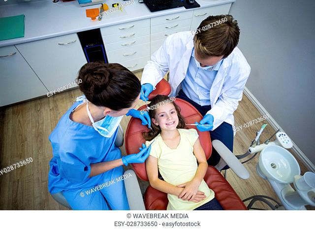 Dentists examining a young patient