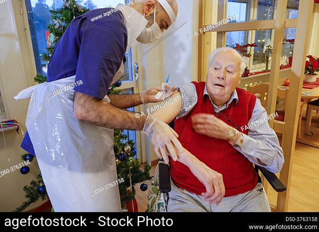 Stockholm, Sweden A senior man gets a Pfizer-BioNTech Covid-19 vaccine in a senior home from a male nurse