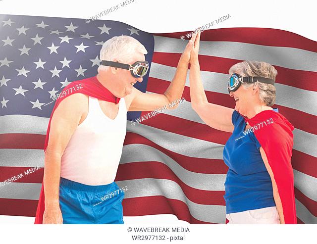 senior people high fiving against american flag