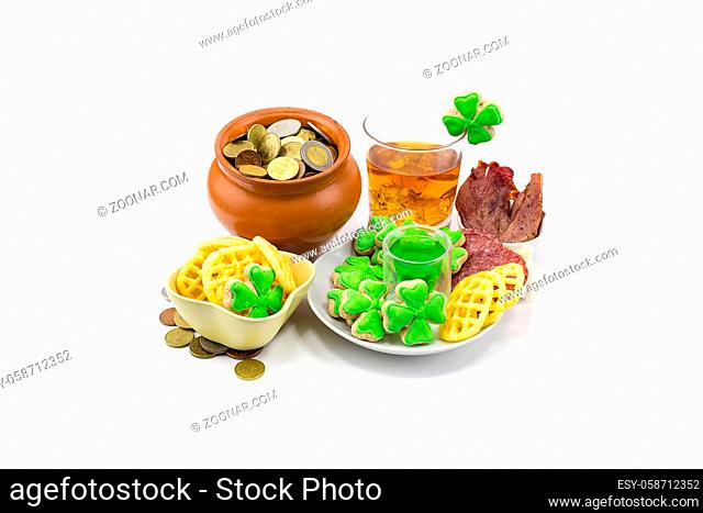 Scotch whiskey glass ice extraction pot of gold coins and clover snack plate of meat and biscuits. Saint Patrick?s Day