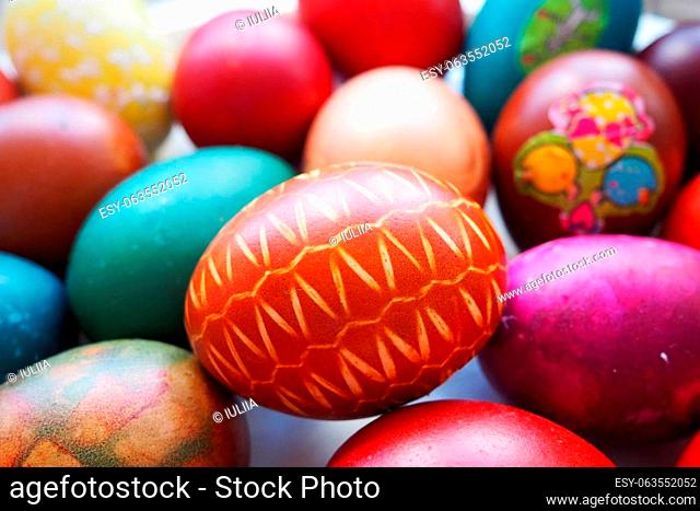Easter basket close-up with colorful eggs. Boiled chicken eggs with red and brown shells, dyed with onion peel according to a traditional recipe