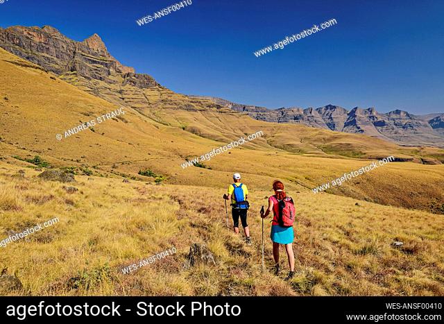 Man and woman hiking in national park at KwaZulu-Natal, Drakensberg, South Africa