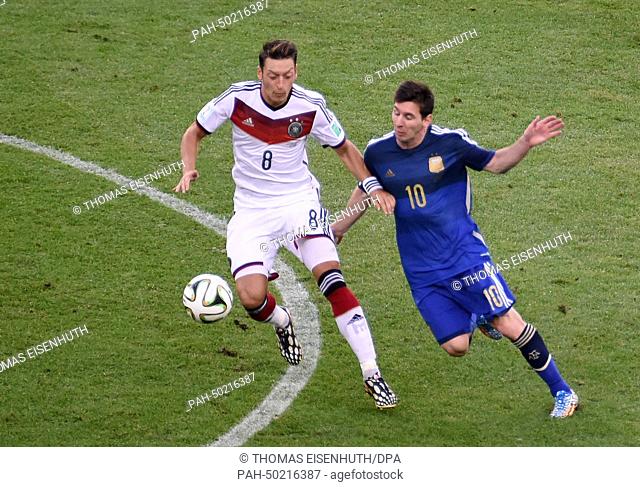 Mesut Oezil (L) of Germany and Lionel Messi of Argentina vie for the ball during the FIFA World Cup 2014 final soccer match between Germany and Argentina at the...