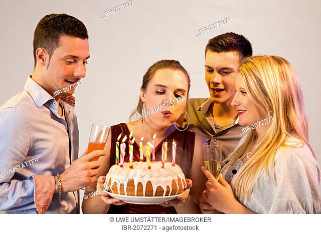 Group of young people celebrating with birthday cake