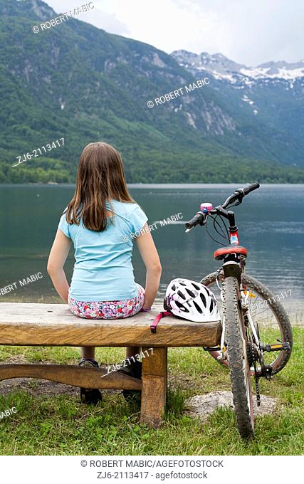 Girl on the bench by the lake, Slovenia Bohinj Gorenjska Julian Alps