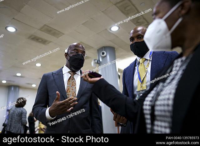 Senator Raphael Warnock, a Democrat from Georgia, wears a protective mask while speaking to members of the press in the Senate Subway at the U.S