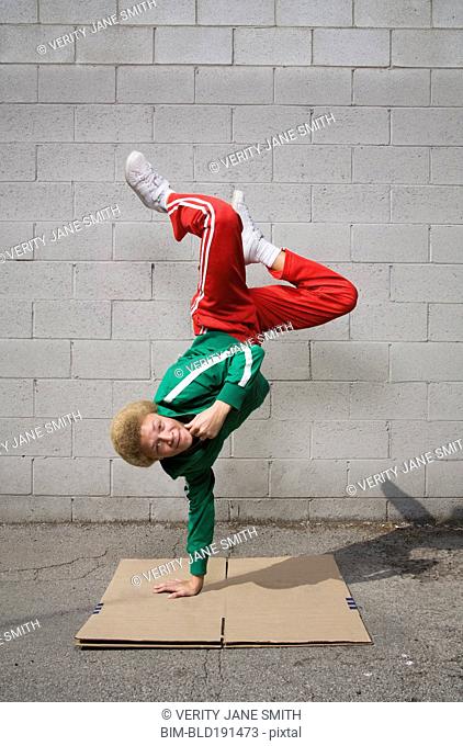 Mixed race boy breakdancing