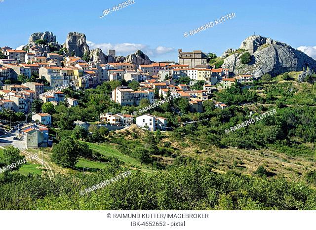 View of mountain village Pietrabbondante with medieval tower and church Chiesa di Santa Maria Assunta on rock Morg Caraceni, Pietrabbondante, Molise, Italy