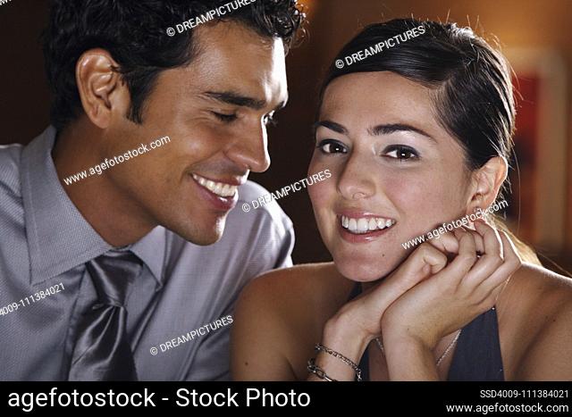 Close up of well dressed Hispanic couple smiling