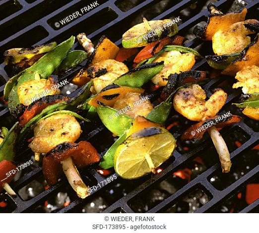 Scampi and vegetable kebabs on grill