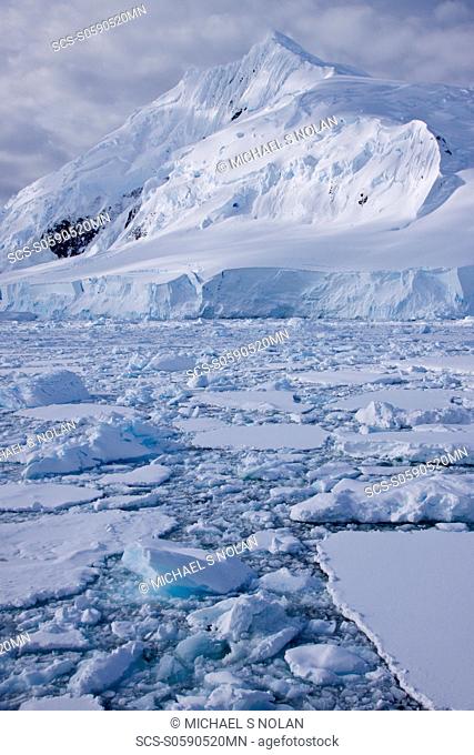 The Lindblad Expeditions ship National Geographic Explorer pushes through ice in Crystal Sound, south of the Antarctic Circle, Antarctica
