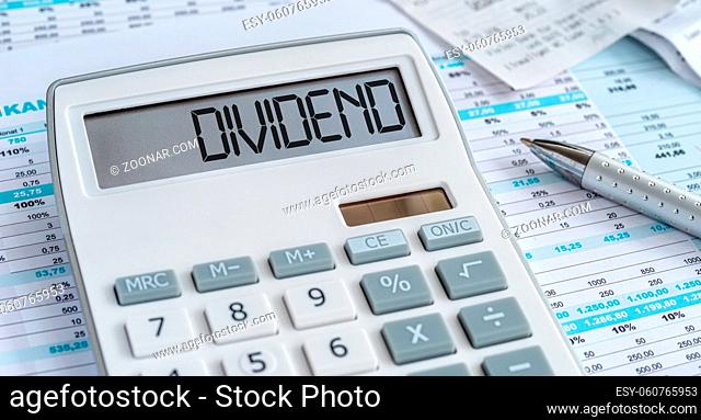 A calculator with the word Dividend on the display
