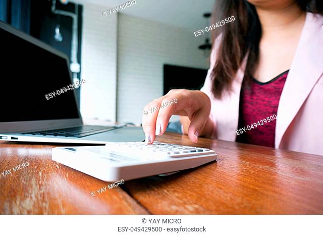 Accountant Working women use calculator with Spreadsheet document information financial concept