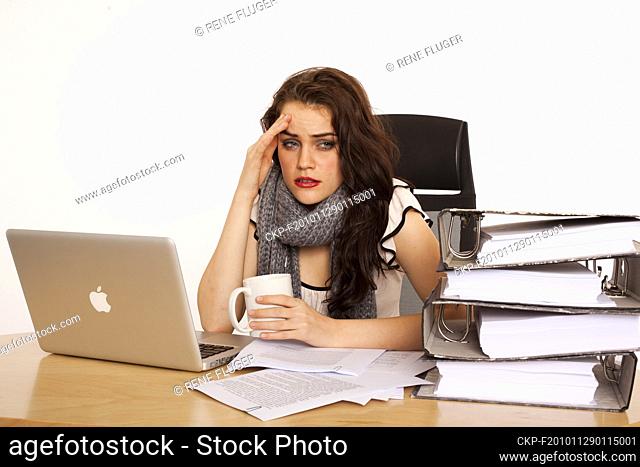 A beautiful young woman, lady, girl, secretary, personal assistant, office work, job, employee, worker, computer, notebook, MacBook Pro, paper work, folders