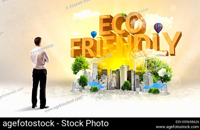 Rear view of a businessman standing in front of ECO FRIENDLY inscription, Environmental protection concept