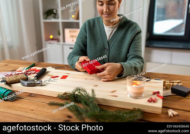 woman making advent calendar on christmas at home