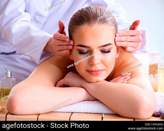 The woman during massage session in spa