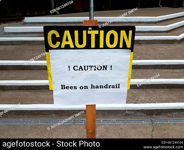 caution bees on handrail sign on steps or stairs