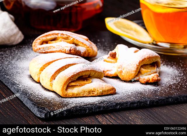 Tea and freshly baked cottage cheese apple cookies garnished with sugar