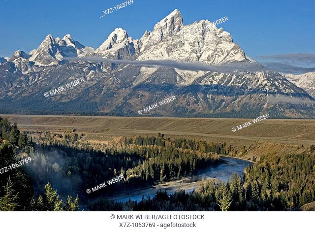 Sunrise on The Grand Teton and the Snake River after an Autumn snow storm near the town of Jackson in Grand Teton National Park Wyoming USA