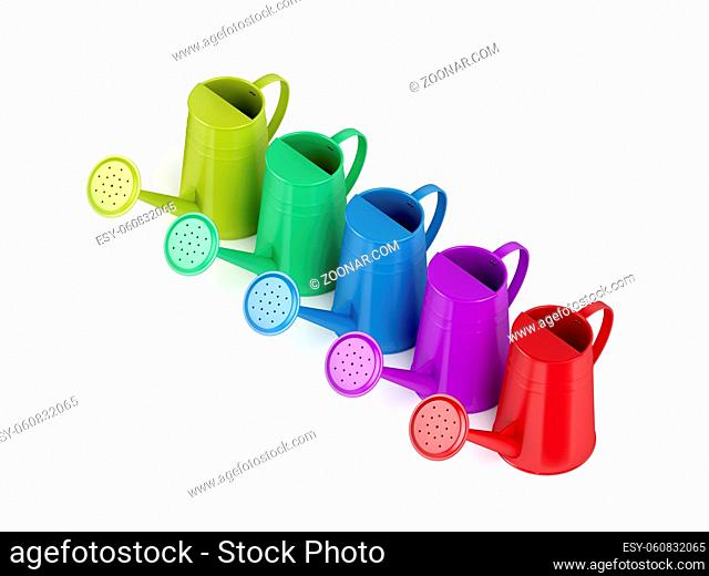Colorful watering cans on white background