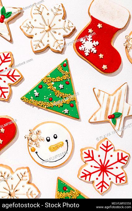 Pattern of various Christmas cookies flat laid against white background