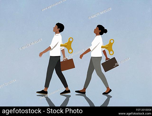 Wind-up business people walking with briefcases