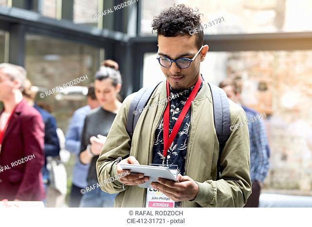 Man using digital tablet at technology conference