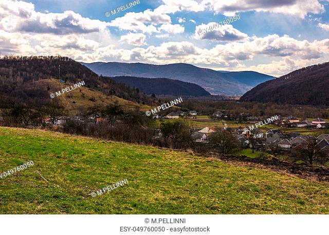 village in mountainous rural are. beautiful countryside landscape in springtime. Cloudy afternoon in Carpathians