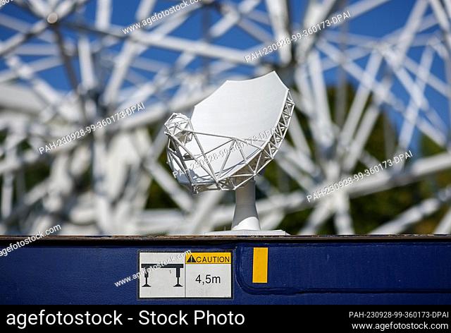 26 September 2023, Saxony, Schkeuditz: The model of an 18-meter parabolic antenna as part of what will be the world's largest radio telescope stands in front of...