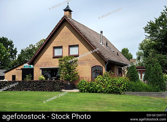Harskamp, Gelderland, The Netherlands - 07 14 2022 - Country house with front yard, surrounded by trees
