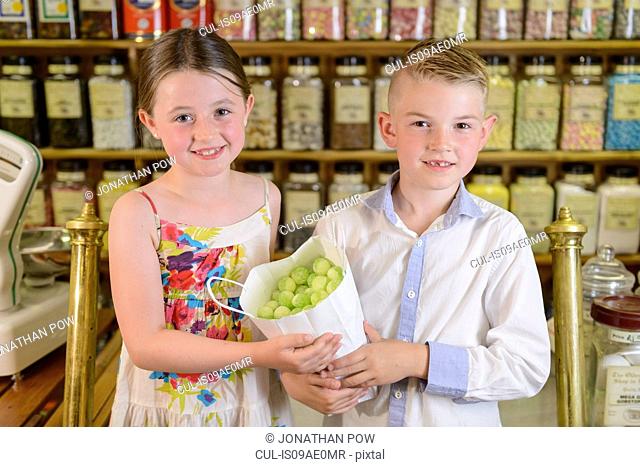 Children holding bag of confectionery