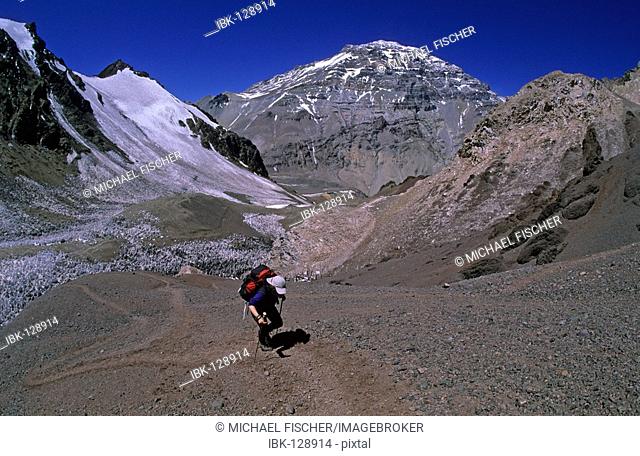 Female climber with the huge westface of Aconcagua in the background Mendoza Argentina