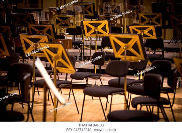 Color image of some orchestra empty seats on a stage