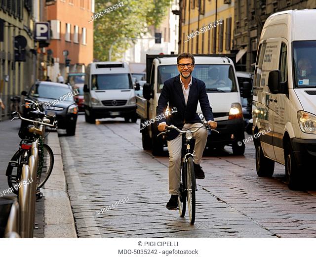 TV host Fabio Fazio rinding a bike in via Pontaccio. Milan, Italy. 17th September 2015
